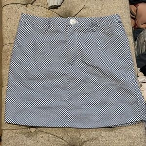 A blue with white patterns on a skirt